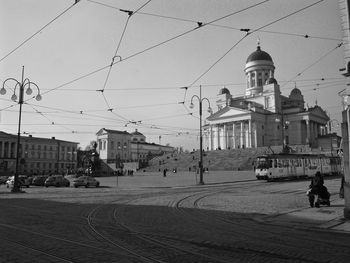 View of city street and buildings against sky