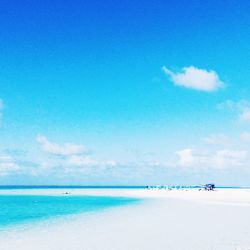 Scenic view of sea against blue sky