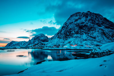 Scenic view of snowcapped mountains against blue sky