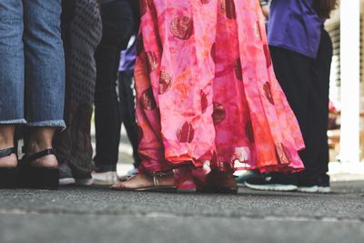 Low section of people standing on street