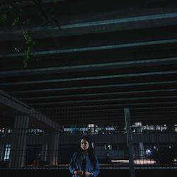 Low angle view of woman in illuminated building