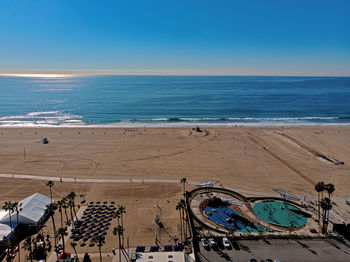 Scenic view of beach against clear blue sky