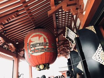 Low angle view of lanterns hanging by building