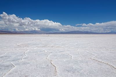 Scenic view of desert against blue sky