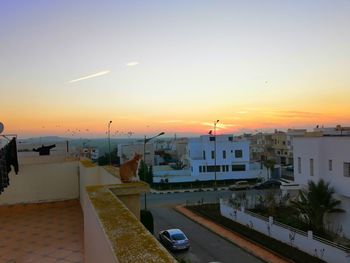 High angle view of buildings against sky during sunset