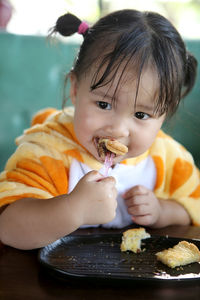 Portrait of cute baby eating food