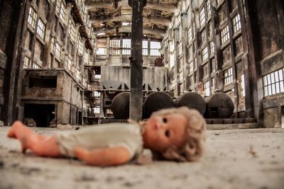 Close-up of doll in abandoned factory