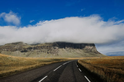 Road by landscape against sky