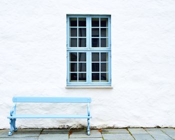 White wall with window with blue frame