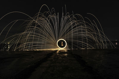 Light painting against sky at night