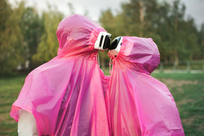 Couple wearing virtual reality simulator on grassy field