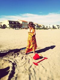 Portrait of woman on beach against sky