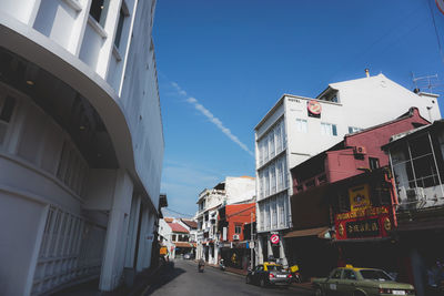 Street amidst buildings in city against sky