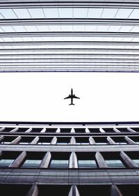 Low angle view of airplane flying against sky