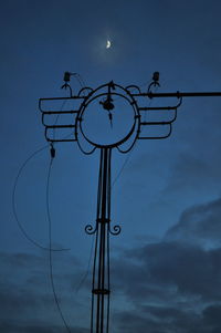 Low angle view of illuminated street light against sky