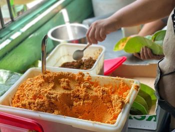 Cropped hand of person preparing food