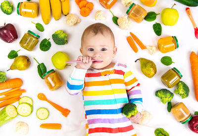 High angle view of cute baby girl playing with toys on table