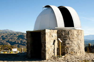 Built structure on landscape against sky