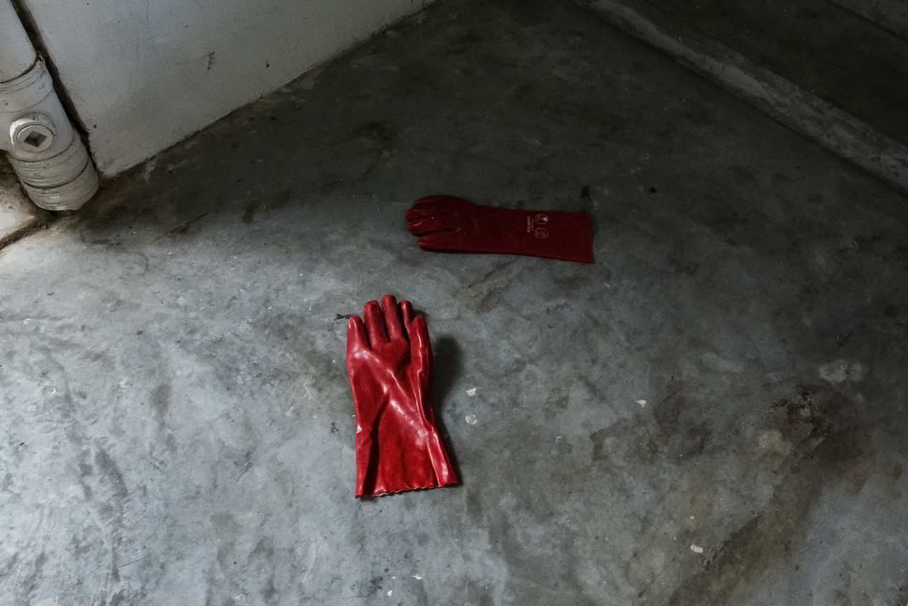 red, indoors, high angle view, no people, still life, close-up, flooring, blood, textile, bed, crime, domestic room, absence, shoe, wall - building feature, architecture, abandoned, mystery, simplicity