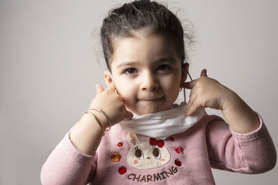 Portrait of cute baby against wall