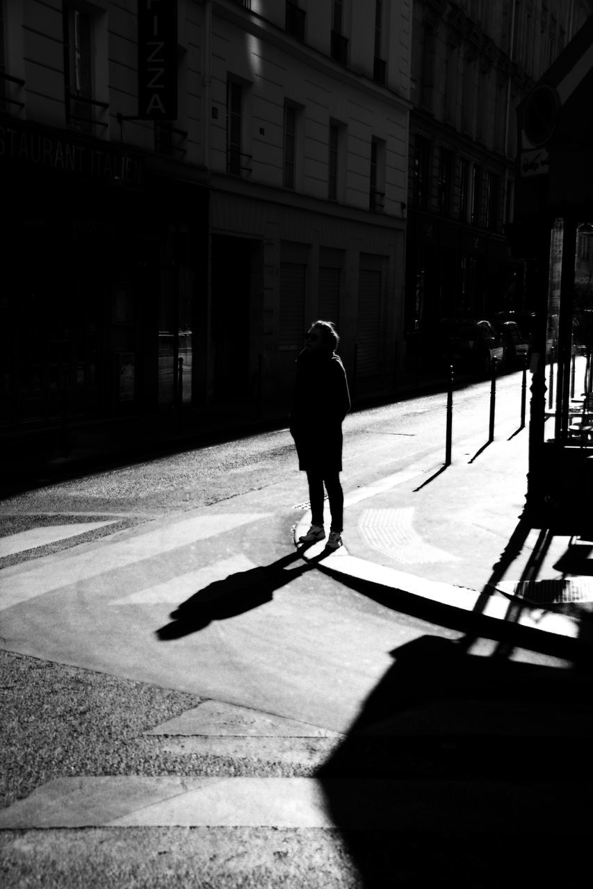 shadow, building exterior, street, architecture, sunlight, built structure, walking, full length, rear view, road, zebra crossing, men, city, sunny, city street, crosswalk, city life, outdoors, day, solitude, focus on shadow, outline