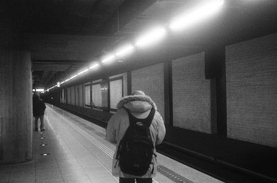 Rear view of woman at subway station