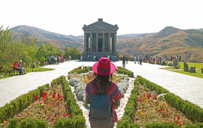 Female visitor looking at the gorgeous architecture of temple of garni, armenia