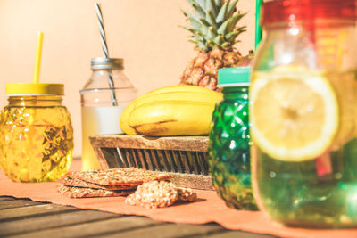 Colorful wooden table with natural food healthy drinks. exotic fruits beverage biscuits and crackers