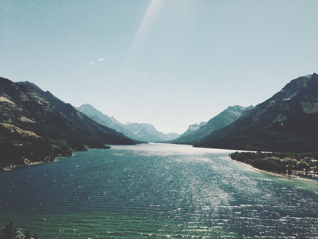 mountain, water, scenics, tranquil scene, tranquility, beauty in nature, mountain range, nature, blue, idyllic, sky, outdoors, non-urban scene, day, no people, remote, landscape, calm, rippled, coastline, non urban scene, majestic, sunny, tourism