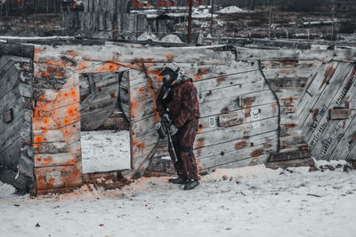 Rear view of working at snow during winter