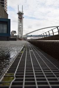 View of railroad tracks by buildings against sky