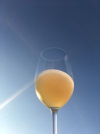 Close-up of beer glass against clear sky