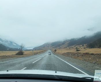 Road seen through car windshield