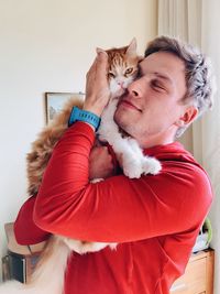 Young woman with cat at home