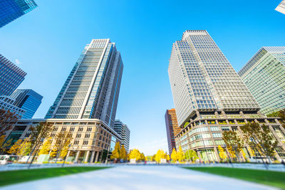 Low angle view of modern buildings against clear blue sky