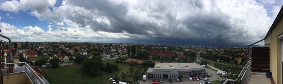 Cityscape against cloudy sky