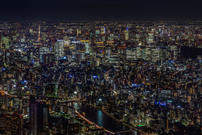 High angle view of city lit up at night