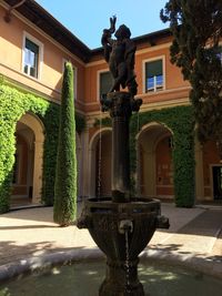 Statue of fountain in front of building