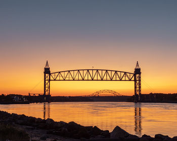 Silhouette bridge against sky during sunset