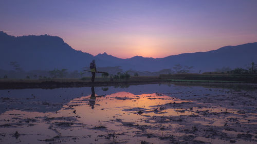 Scenic view of lake against sky during sunset