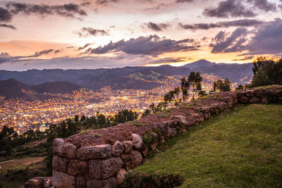 Sunset near city and distant mountains