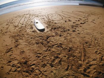 High angle view of footprints on sand at beach
