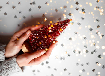 Cropped hand of woman holding christmas decoration