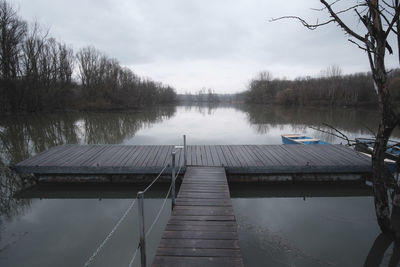 Pier over lake against sky