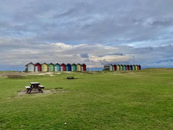 Scenic view of beach huts against sky