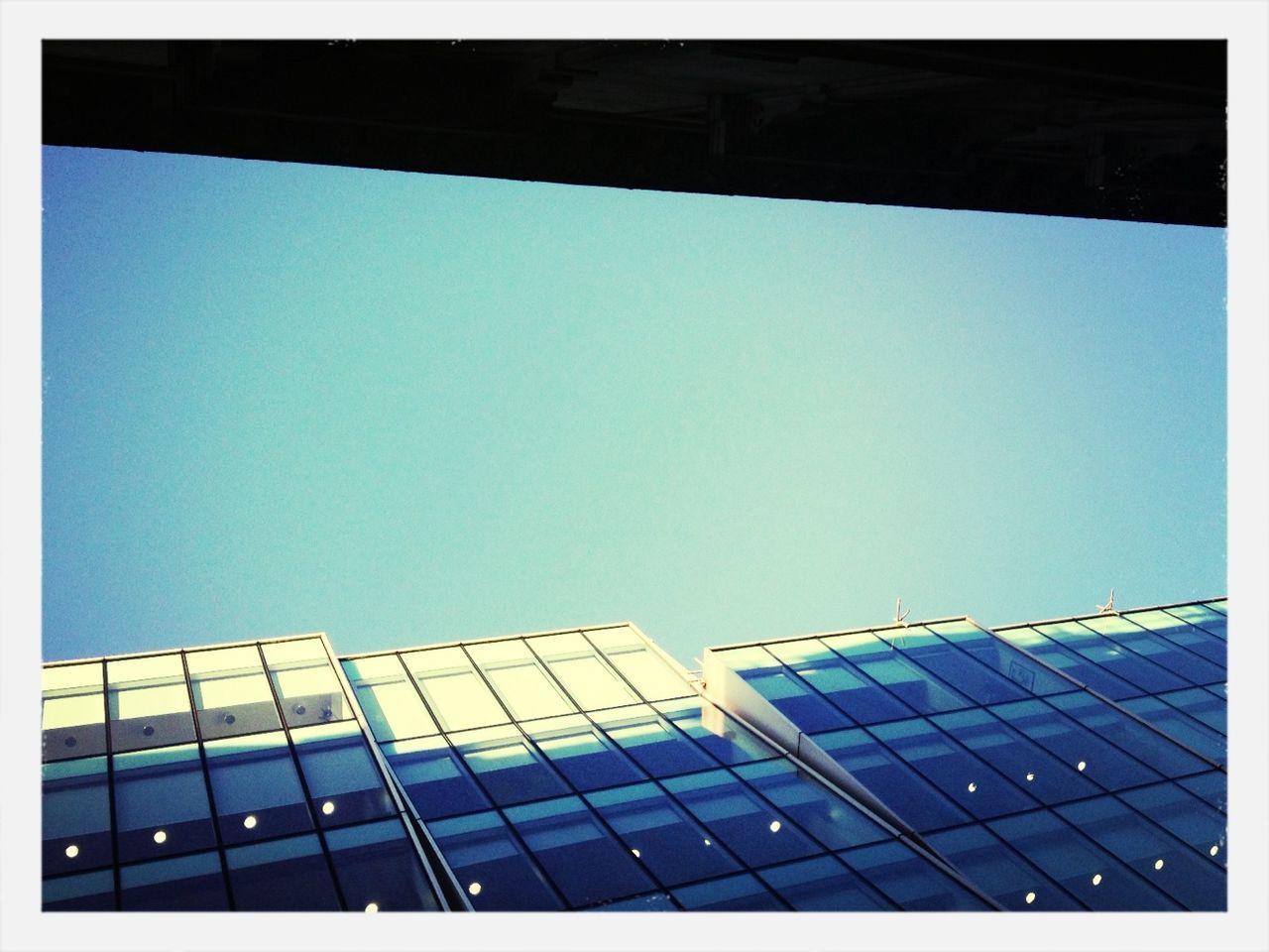 clear sky, architecture, built structure, low angle view, building exterior, blue, transfer print, copy space, modern, auto post production filter, office building, city, building, skyscraper, day, glass - material, tower, outdoors, window, sky