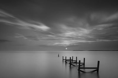 Scenic view of calm sea against cloudy sky