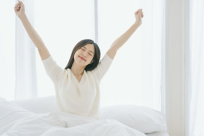 Lazy young woman relaxing on bed at home