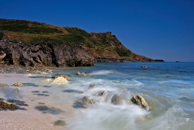 Scenic view of sea against clear blue sky