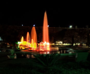 Illuminated ferris wheel at night